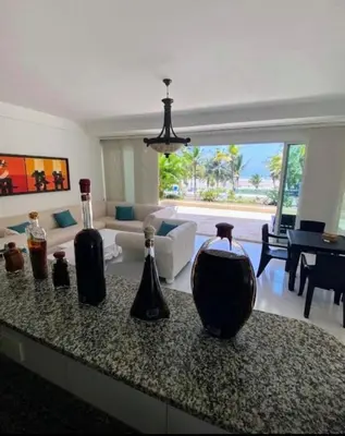 a living room with a counter with vases on it at Apartamento con vista frontal al mar. in Cartagena de Indias