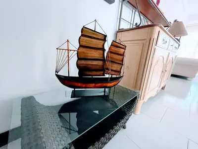 a wooden boat on a glass table in a room at Apartamento con vista frontal al mar. in Cartagena de Indias