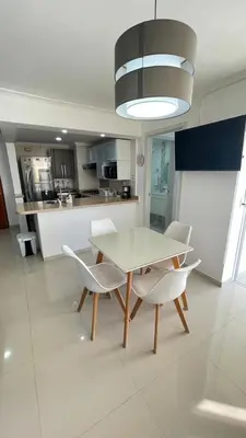 a dining room with a table and chairs in a kitchen at Cabrero Beach 906 in Cartagena de Indias