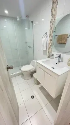 a white bathroom with a toilet and a sink at Cabrero Beach 906 in Cartagena de Indias