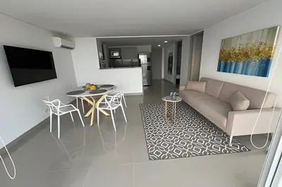 a living room with a couch and a table at Apartamento 2 Dormitorios Vista Mar. Piscina in Cartagena de Indias