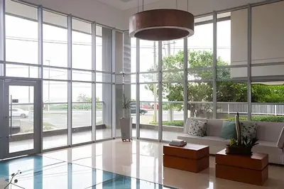 a living room with a couch and large windows at Apartamento 2 Dormitorios Vista Mar. Piscina in Cartagena de Indias