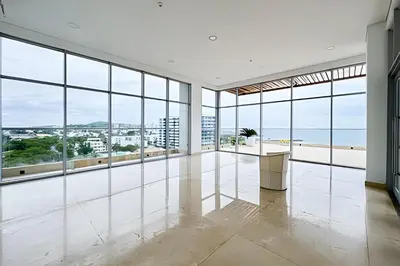 an empty room with large windows and a view of the ocean at Apartamento 2 Dormitorios Vista Mar. Piscina in Cartagena de Indias