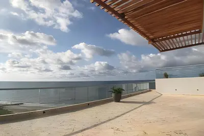 a view of the ocean from the balcony of a house at Apartamento 2 Dormitorios Vista Mar. Piscina in Cartagena de Indias