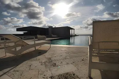 a view of a dock with a bench and the ocean at Apartamento 2 Dormitorios Vista Mar. Piscina in Cartagena de Indias
