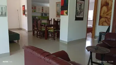 a living room with a couch and a table and chairs at TOLU ALOJAMIENTOS Oasis tropical elegante, relax, apartamento amoblado in San Silvestre