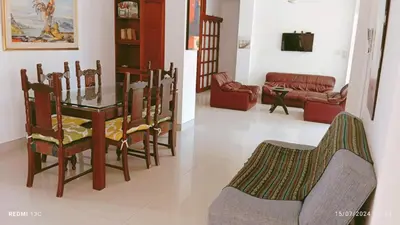a dining room and living room with a table and chairs at TOLU ALOJAMIENTOS Oasis tropical elegante, relax, apartamento amoblado in San Silvestre