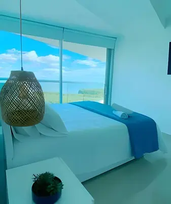 a bedroom with a bed and a large window at 2 dormitorios Morros. Vistas y salida playa in Cartagena de Indias