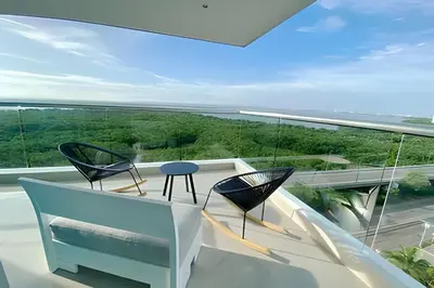 a room with two chairs and a table on a balcony at 2 dormitorios Morros. Vistas y salida playa in Cartagena de Indias