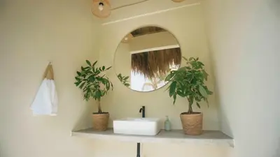 a bathroom with a sink and two potted plants at Cosamui Beach House in San Bernardo del Viento