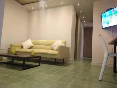 a living room with a couch and a table and a tv at Confortable apto en Coveñas in Coveñas