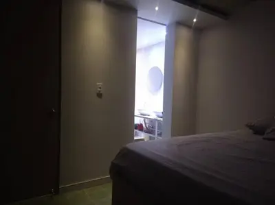 a bedroom with a bed and a door with a window at Confortable apto en Coveñas in Coveñas