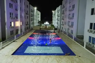 a swimming pool in the middle of a building at night at Confortable apto en Coveñas in Coveñas