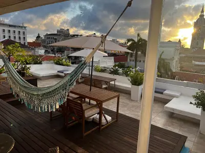 a hammock on a balcony with a view of a city at Casa Lazuli 303 Cartagena in Cartagena de Indias