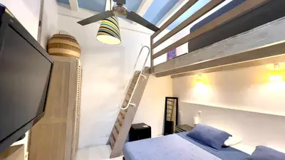 a bedroom with a bunk bed and a ladder at Casa Lazuli 303 Cartagena in Cartagena de Indias