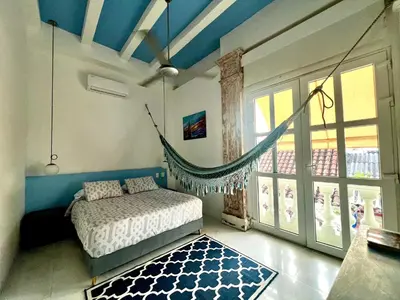 a bedroom with a bed and a hammock in it at Casa Lazuli 303 Cartagena in Cartagena de Indias