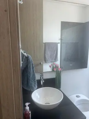 a bathroom with a white sink and a toilet at Infinitum de lujo in Cartagena de Indias