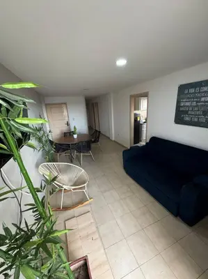 a living room with a couch and a table at Apartamento frente a la playa in Cartagena de Indias