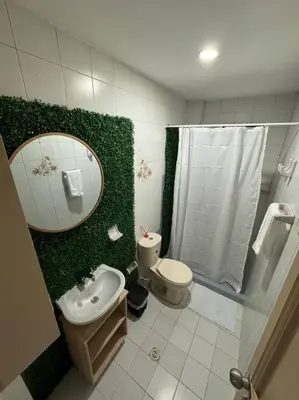 a bathroom with a toilet and a sink and a mirror at Apartamento frente a la playa in Cartagena de Indias
