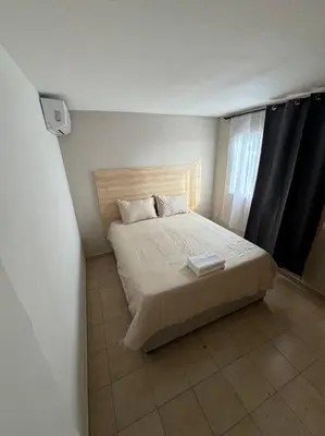 a bedroom with a bed in a white room at Apartamento frente a la playa in Cartagena de Indias