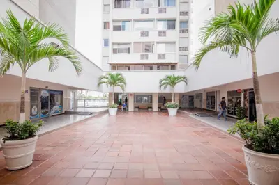 an empty hallway with palm trees in a building at Exclusivo Apartamento con vista al mar in Cartagena de Indias