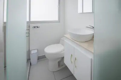 a white bathroom with a toilet and a sink at Exclusivo Apartamento con vista al mar in Cartagena de Indias