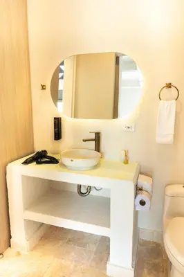 a bathroom with a sink and a mirror at Ilukas & Resort Villas in Coveñas