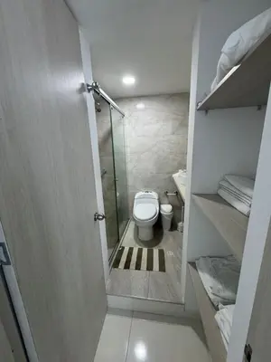 a bathroom with a toilet and a glass shower at Apartamento en Coveñas in Coveñas