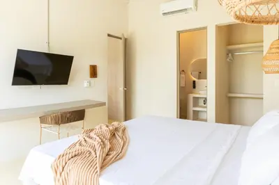 a bedroom with a bed and a tv on a wall at Cabaña privada & Villas Iluka in Coveñitas