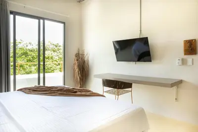 a bedroom with a bed and a desk and a tv at Cabaña privada & Villas Iluka in Coveñitas