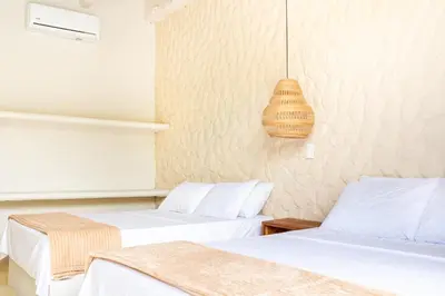a room with two beds and a pendant light at Cabaña privada & Villas Iluka in Coveñitas