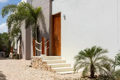 a white house with stairs and a cactus at Cabaña privada & Villas Iluka in Coveñitas