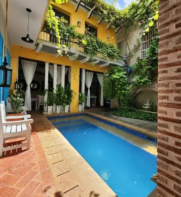 a swimming pool in front of a building at CASA AMOR, Old Town 4 BDR in Cartagena de Indias