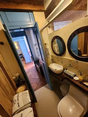 a bathroom with a toilet and a sink and a mirror at CASA AMOR, Old Town 4 BDR in Cartagena de Indias
