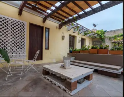 a patio with a bench and a table at CASA AMOR, Old Town 4 BDR in Cartagena de Indias