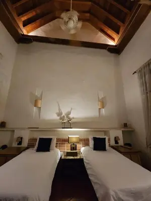 two beds in a room with a ceiling fan at CASA AMOR, Old Town 4 BDR in Cartagena de Indias