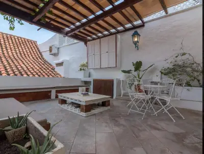 an outdoor patio with a table and chairs at CASA AMOR, Old Town 4 BDR in Cartagena de Indias