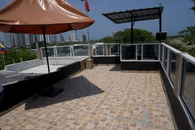 a patio with an umbrella on top of a building at Casa Tranquila in Cartagena de Indias