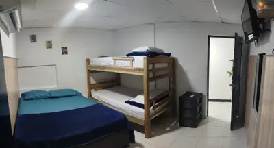 a small room with a bunk bed and a small room with a small bed at Hermosa casa cerca de la playa in Cartagena de Indias