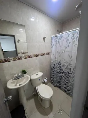 a bathroom with a toilet and a sink and a shower at Shekinah House in Cartagena de Indias