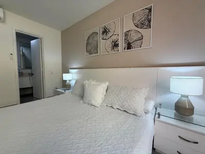 a bedroom with a bed and two pictures on the wall at Morros 922 Beach House in Cartagena de Indias