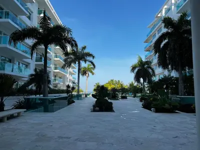 a courtyard with palm trees and a building at Morros 922 Beach House in Cartagena de Indias