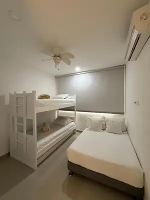 a bedroom with two bunk beds and a ceiling fan at Morros 922 Beach House in Cartagena de Indias