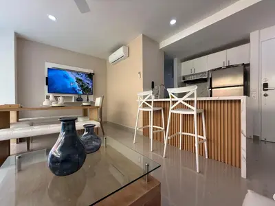 a living room with a vase on a glass table at Morros 922 Beach House in Cartagena de Indias