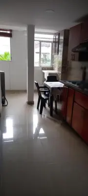 a kitchen with a table and chairs in a room at Apartamento El Cabrero in Cartagena de Indias