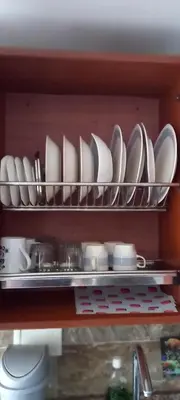 a shelf filled with plates and dishes in a kitchen at Apartamento El Cabrero in Cartagena de Indias