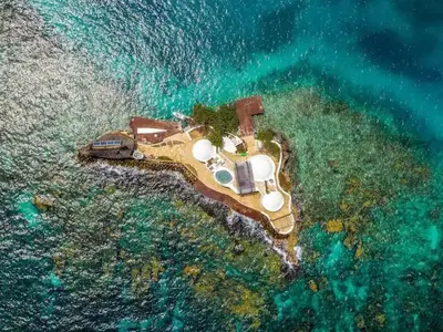 an aerial view of a small island in the ocean at Isla Pelícano in Isla Grande