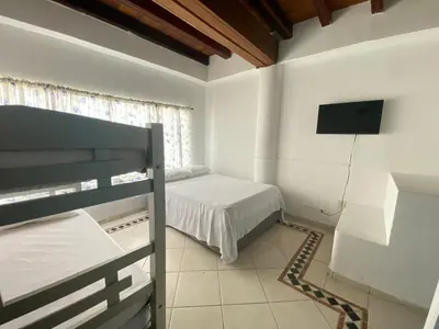 a bedroom with a bed and a flat screen tv at Muy cerca del mar, areopuerto y centro histórico in Cartagena de Indias