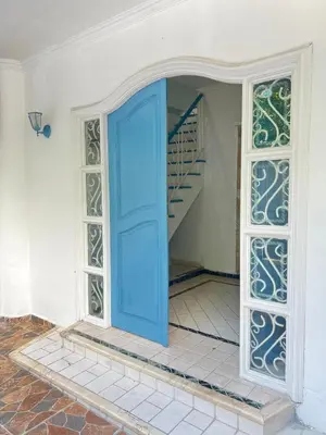 a blue door in a room with a staircase at Muy cerca del mar, areopuerto y centro histórico in Cartagena de Indias