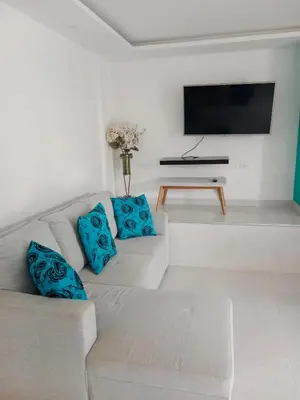 a living room with a couch and a flat screen tv at Casa Topacio in Cartagena de Indias